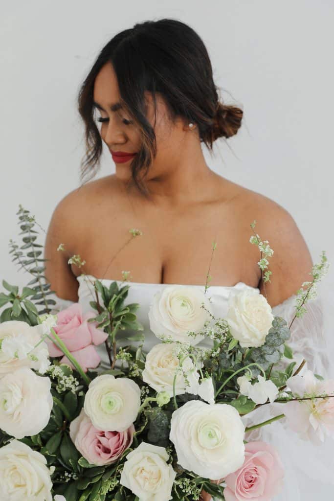Beautiful bridal bouquet featuring white and pink roses with greenery.