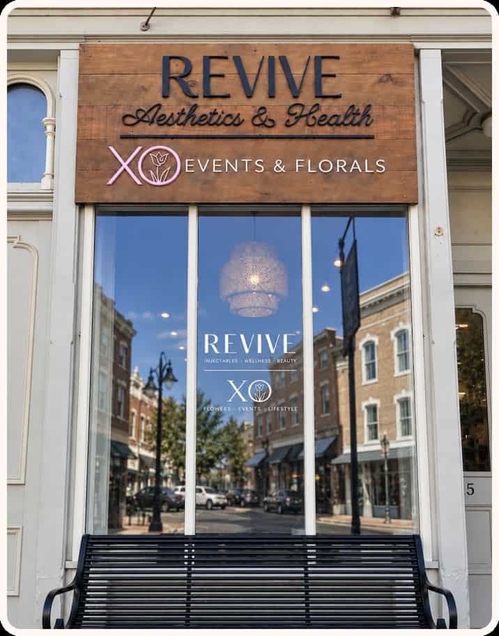 XO Events & Florals storefront with large glass windows and wooden sign.