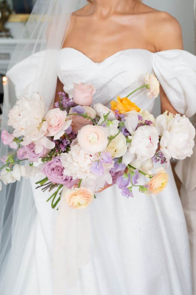 Elegant bridal bouquet with pastel roses and peonies for wedding.