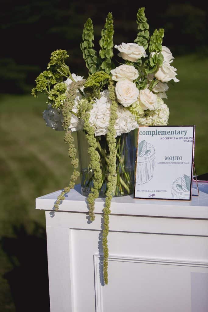 Beautiful white floral centerpiece with roses and greenery for special occasions.