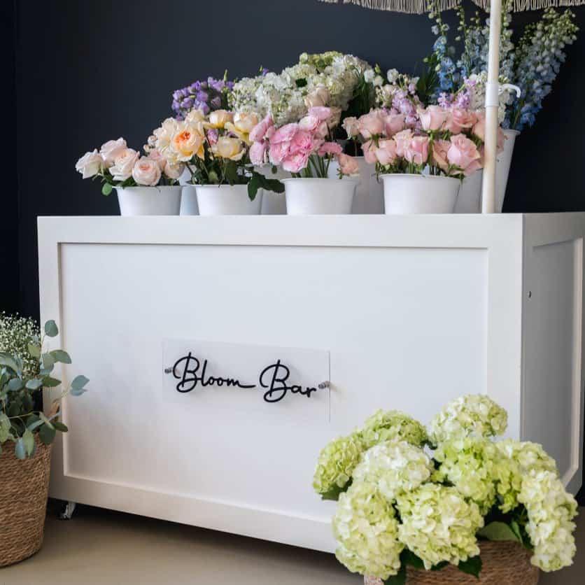 Elegant floral display at XO Flowers Bloom Bar with roses and hydrangeas.