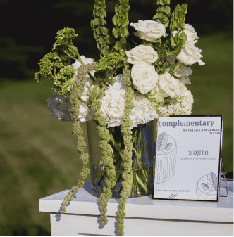 Beautiful white floral centerpiece with roses and greenery for special occasions.