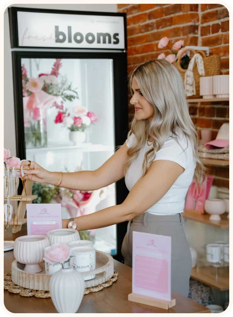 Woman shopping for floral arrangements at XO Flowers in a boutique shop.