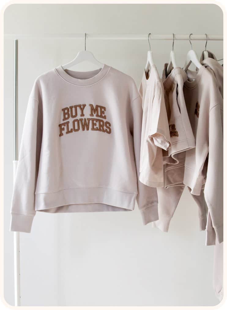 Custom sweatshirts with 'Buy Me Flowers' text at XO Flowers.